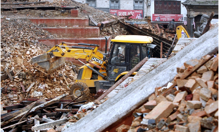 A JCB backhoe loader pictured in Kathmandu, Nepal, yesterday (April 28th) digging through the debris of a collapsed ancient temple after the earthquake. JCB has donated 10 backhoes to the relief effort.