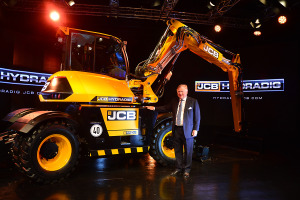JCB Chairman Lord Bamford pictured with the newly launched JCB Hydradig.