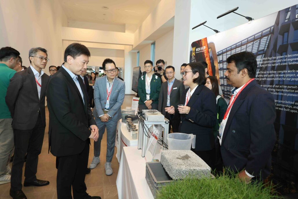 Minister for National Development Mr Chee Hong Tat viewing Woh Hup and SIT’s Steel Slag Porous Concrete Pavement demonstration